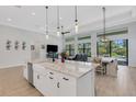 Bright, spacious kitchen with an island, stainless steel appliances, and an adjacent dining area at 204 Corelli Dr, Nokomis, FL 34275