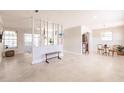 Bright and open living room with terrazzo flooring, modern partition, and neutral paint colors at 22275 Belinda Ave, Port Charlotte, FL 33952