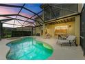 Private screened-in pool and spa area with a seating area for relaxing and entertaining at 235 River Enclave Ct, Bradenton, FL 34212