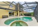 Spacious screened-in patio with a custom-shaped pool and spa at 235 River Enclave Ct, Bradenton, FL 34212