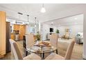 Open-concept living space with an eat-in kitchen, dining area, and living room at 2419 Riverbluff Pkwy # V233, Sarasota, FL 34231
