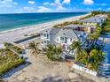Aerial view of beachfront property with stunning views of ocean, beach, and surrounding neighborhood at 2500 Gulf N Dr, Bradenton Beach, FL 34217