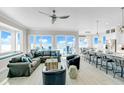 Bright living room with ocean view, sectional couch, and adjacent kitchen at 2500 Gulf N Dr, Bradenton Beach, FL 34217