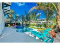Resort-style pool with lounge chairs, tropical landscaping, and inviting atmosphere for relaxation at 2500 Gulf N Dr, Bradenton Beach, FL 34217