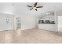 Cozy living room with tile flooring, and direct access to the kitchen and outdoor views at 2575 Johannesberg Rd, North Port, FL 34288