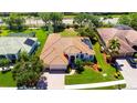 An aerial view of a single Gathering home with solar panels and a well manicured lawn at 2729 Harvest Dr, Sarasota, FL 34240