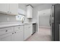 Well-appointed kitchen featuring white cabinets, stainless steel appliances, and ample counter space for meal preparation at 2739 Palmadelia Ave, Sarasota, FL 34234