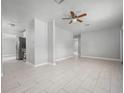 Spacious living room boasting neutral paint and tile floors throughout, complemented by a ceiling fan for added comfort at 2739 Palmadelia Ave, Sarasota, FL 34234