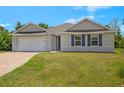 Charming single-story home with brick driveway, shutters, and attached two car garage at 27519 Pasto Dr, Punta Gorda, FL 33983