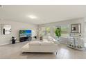 Spacious living room with tile floors, bright windows, and modern decor at 27519 Pasto Dr, Punta Gorda, FL 33983