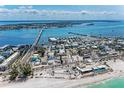 An aerial view of the property located close to the beach and a pier at 301 Highland Ave # 3, Bradenton Beach, FL 34217