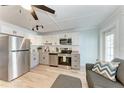 Modern kitchen features stainless steel appliances and white cabinetry at 301 Highland Ave # 3, Bradenton Beach, FL 34217