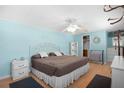 Bright bedroom with wood floors, ceiling fan, and comfortable bedding, creating a relaxing atmosphere at 307 White Oak Way, Sarasota, FL 34237