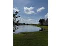Beautiful water view showcases the community lake with lush greenery and clear blue sky, highlighting serene setting at 4037 Crockers Lake Blvd # 14, Sarasota, FL 34238