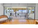 Inviting screened lanai with comfortable seating and scenic waterfront views at 4234 Gulf Of Mexico Dr # G2, Longboat Key, FL 34228