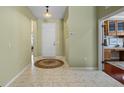 Open foyer with tile flooring, leading to the kitchen; great home for entertaining at 4402 Natures Reach Ter, Parrish, FL 34219