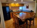 Functional kitchen featuring a breakfast bar with cooktop and dark countertops at 4607 W North B St # 105, Tampa, FL 33609