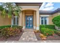 Close up of the beautiful glass front door with lush garden views and colorful flower beds at 4818 88Th E St, Bradenton, FL 34211