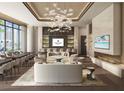 Elegant resident lounge with stylish seating, custom lighting, fireplace and bar area at 555 Quay Commons # 602, Sarasota, FL 34236