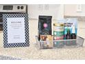 Welcome basket on granite countertop with teas and snacks for new homeowners at 6157 Midnight Pass Rd # E73, Sarasota, FL 34242