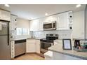 Bright kitchen featuring stainless steel appliances and white cabinetry at 6157 Midnight Pass Rd # E73, Sarasota, FL 34242