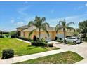 Inviting exterior showcasing a driveway with palm trees and manicured landscaping at 635 Chipper Dr, Sun City Center, FL 33573