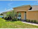 The front entrance is adorned with beautiful landscaping and outdoor seating at 635 Chipper Dr, Sun City Center, FL 33573