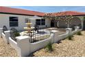 Enclosed courtyard with a fountain, shade tree, patio set, and decorative fencing at 6524 Senegal Palm Way, Apollo Beach, FL 33572
