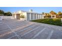 Modern home exterior with geometric hardscape, decorative grasses and textured stone driveway at 7647 Sanderling Rd, Sarasota, FL 34242