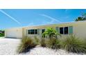 Charming single-story home featuring manicured landscaping and ample natural light at 791 Saint Judes Dr N, Longboat Key, FL 34228