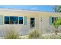 Welcoming facade with neat landscaping, complemented by the house number at 791 Saint Judes Dr N, Longboat Key, FL 34228