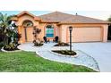 Charming home featuring a manicured front yard with stone accents and welcoming curb appeal at 834 Springwood Cir, Bradenton, FL 34212