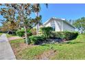 Well-maintained home exterior featuring lush green lawn and meticulously trimmed shrubs at 9022 Coachman Dr, Venice, FL 34293