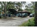 View of the yard area with multiple vehicles and outdoor decor at 9625 Erie Rd, Parrish, FL 34219