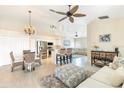 Open concept living room featuring a dining table, kitchen area, and comfortable seating at 10202 L Pavia Blvd # 10202, Venice, FL 34292