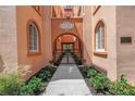 Elegant condo entryway featuring classic architecture, manicured landscaping, and secure gated access at 1221 N Palm Ave # 303, Sarasota, FL 34236