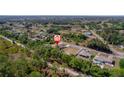 Aerial view of a home nestled among lush greenery in a quiet neighborhood at 12214 Hernando Rd, North Port, FL 34287