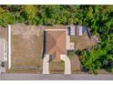 Birds eye view showing the house, yard, and a shed in a wooded lot at 12214 Hernando Rd, North Port, FL 34287