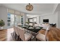 Open-concept dining area featuring a modern table setting, contemporary lighting, and a view to the living room at 1350 Main St # 1703, Sarasota, FL 34236