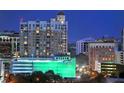 Exterior night shot of the high-rise building showing the many lights and parking structure at 1350 Main St # 1703, Sarasota, FL 34236
