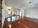 Open concept living room with hardwood floors, arched doorways, and natural light at 13809 18Th E Pl, Bradenton, FL 34212