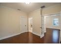 Bedroom with hardwood floors and view into the ensuite bathroom and hallway at 1420 E Frierson Ave, Tampa, FL 33603