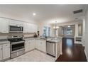 Bright eat-in kitchen with stainless steel appliances, stone countertops, and shaker cabinets at 1420 E Frierson Ave, Tampa, FL 33603
