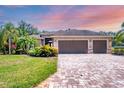 Charming single-story home featuring a three-car garage, manicured landscaping and a brick paver driveway at 15208 21St E Ave, Bradenton, FL 34212
