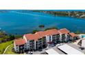 Condo building with covered parking and water views at 1608 Stickney Point Rd # 304, Sarasota, FL 34231