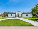 Stunning single-story home with pristine landscaping and a welcoming circular driveway at 180 Lookout Point Dr, Osprey, FL 34229