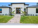 Inviting front entrance featuring double doors, stone steps, and manicured landscaping at 180 Lookout Point Dr, Osprey, FL 34229