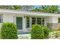 Close-up of the home's entrance, showcasing a green door and bay window at 2110 Craft Ln, Sarasota, FL 34239