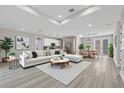 Bright, open-concept living space with modern furnishings, recessed lighting and wood-look flooring at 2258 Margaret Ln, North Port, FL 34286