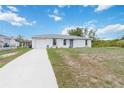Charming one-story home with a well-manicured lawn, an attached garage, and inviting curb appeal at 2341 Sheila Ln, North Port, FL 34286